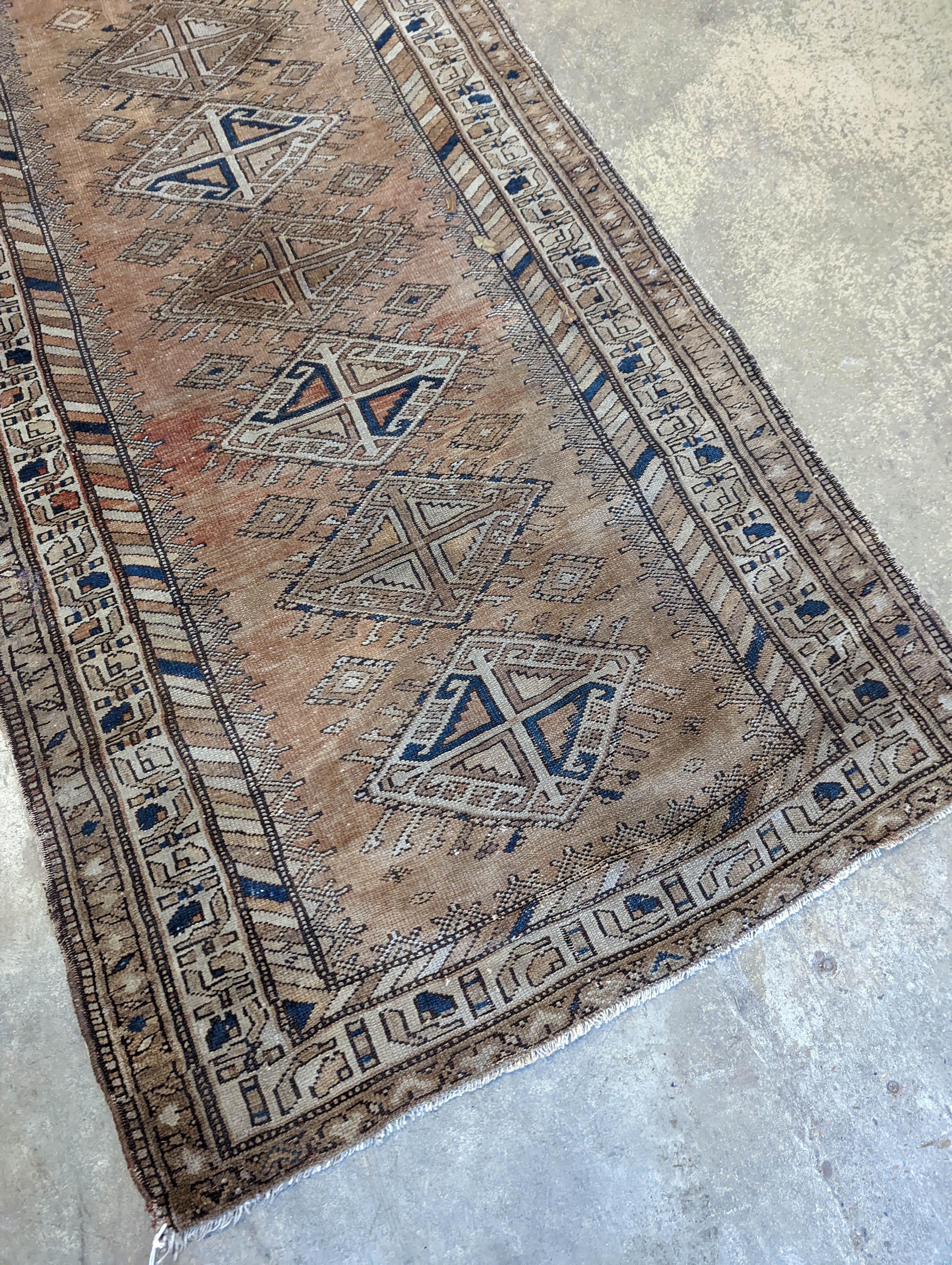 An antique Caucasian red ground runner, 372 x 106cm